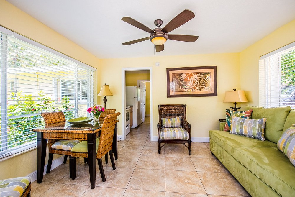 Bright cottage living area with dining table and tropical decor