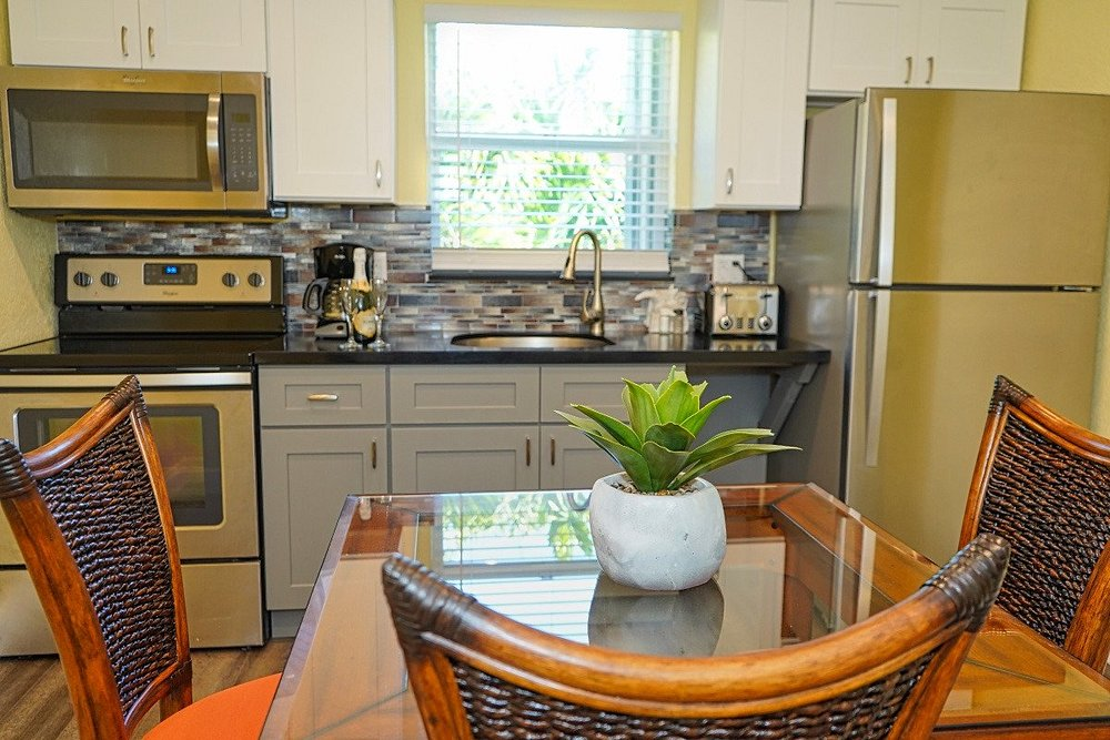Compact kitchen with dining table inside a resort accommodation